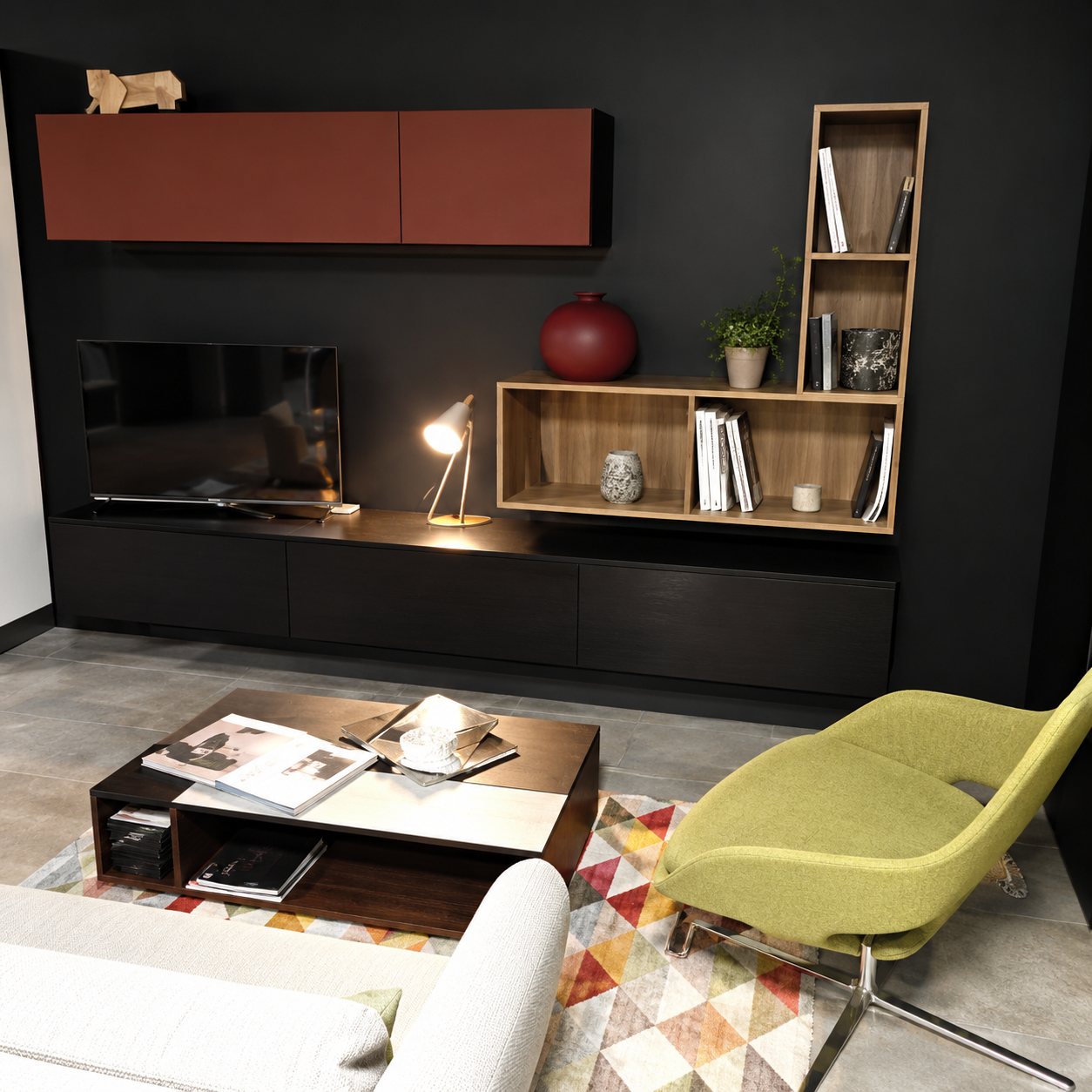 Meuble TV noir et rouge brique avec un fauteuil vert
