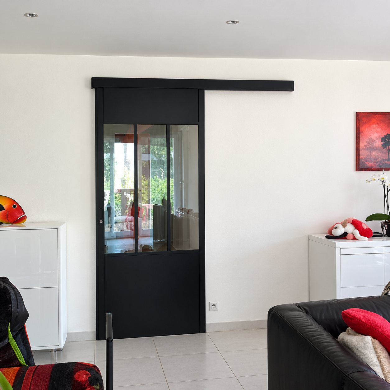 Porte coulissante vitrée à cadre noir dans un séjour